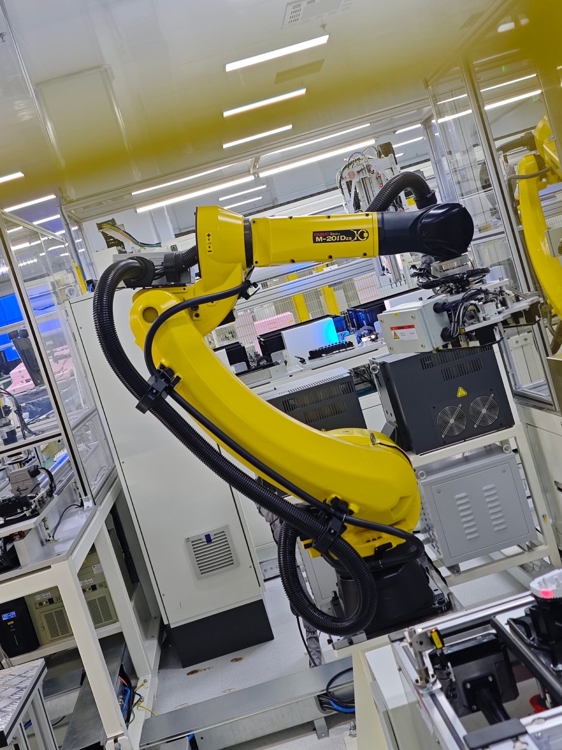 Industrial robot operating beside automated production equipment